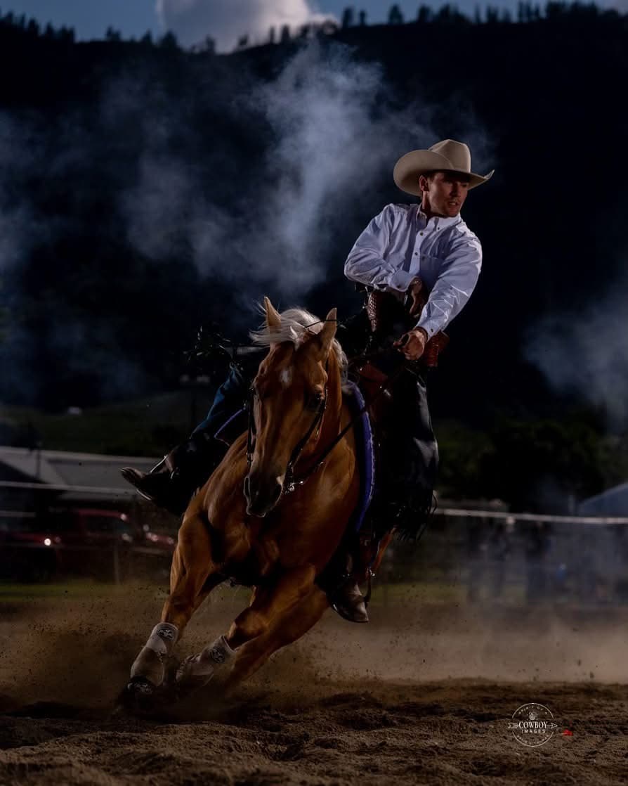 Mounted shooter leaning into a turn at night